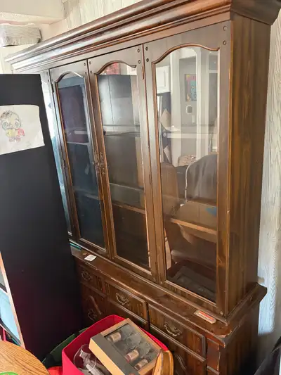 This used china cabinet features a beautiful wood finish and glass door display, perfect for showcas...