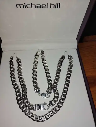 Silver-tone curb chain necklace and matching bracelet. Lobster clasp closures. Set includes both pie...