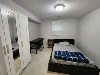 A fully furnished private room in the basement of a house with separate entrance at street level ava...