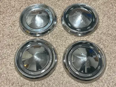 Four 56 1956 Chev car / wagon dog dish hubcaps for 150 and 210 models. Two in very good condition, o...