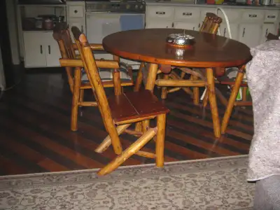 pine table & 2 captain chairs & 2 tall backs. The table top has some markings on it. The set is very...
