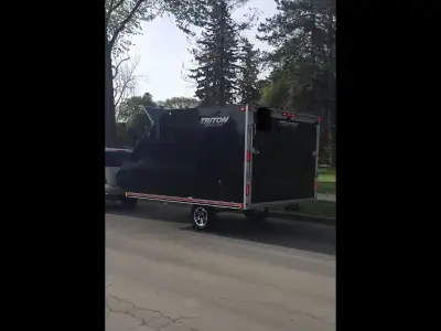 2011 TRITON ENCLOSED ALUMINUM TRAILER. PRESSURE TREATED FLOORING. SWIVEL 20 VOLT DEWALT LED INTERIOR...