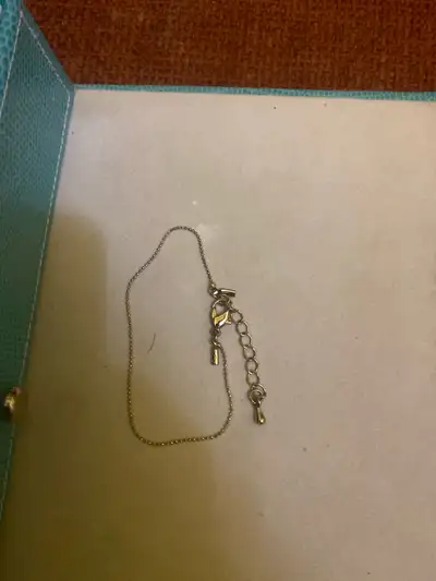 This is a used bracelet with a lobster clasp closure and adjustable length, perfect for adding a del...