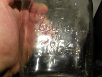 Old Glass Bottle Embossed 'Eau de Vie/Bottled in 1 864'