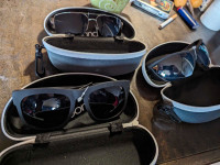 Three pair of brand new sunglasses with cases and tags