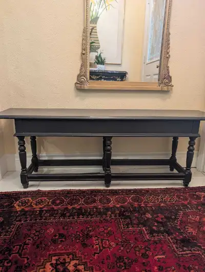 This classic black console bench offers discrete storage. It's perfect for entryways or hallways. Di...