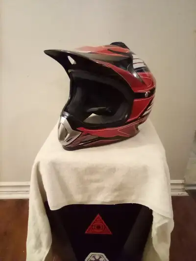 Red, black and white PHX motorcycle helmet. This helmet wasn't used often so the inside is like new...