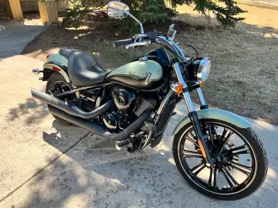Showroom condition! Ride in comfort and style. This sage green 900 custom is powered by a liquid coo...