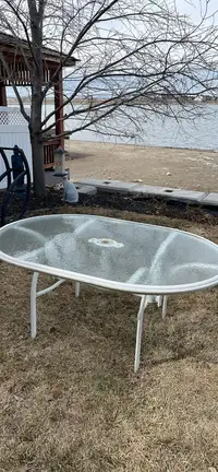  Glass patio table 63” x 44”, comes apart for easier transport