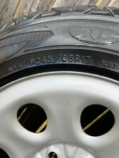 These are R245/65R17 tires mounted on grey steel rims that fit a Chevy or GMC. They have approximate...