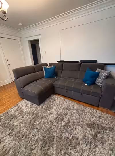 This cozy and stylish right-facing sectional and matching armchair set with an ottoman has been gent...