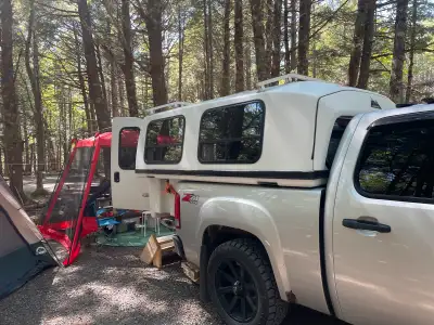 8ft SpaceKap converted truck camper, bed pulls out to a double. Sliding side vent windows with scree...