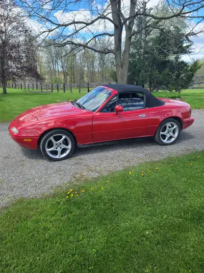 1990 Mazda Miata. Excellent condition. Brand new cloth convertible top with glass rear window. Air c...