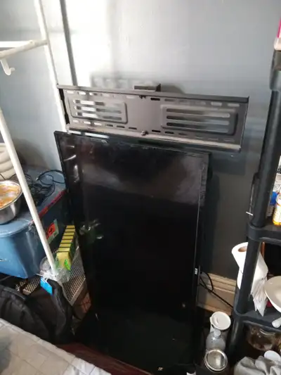 TV with glass bottomed stand with a hight adjustable mount.