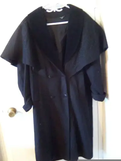 Elegant black wool cape coat featuring a classic design, View more