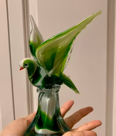 This green and white Murano glass bird statue is a beautiful piece of art glass with intricate detai...