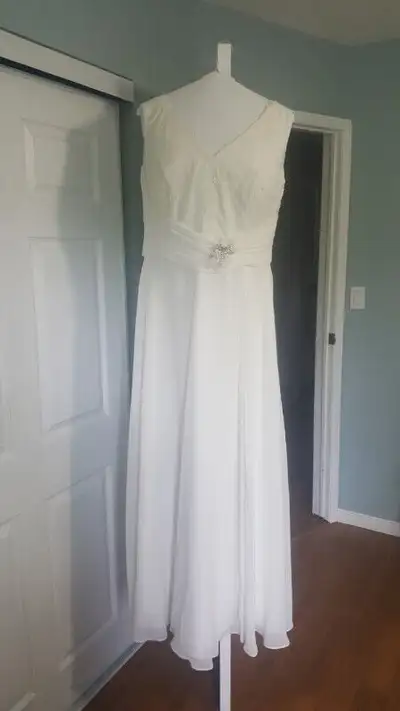 Romantic Bridals ivory wedding dress, size 18. Worn once and professionally dry cleaned. The rhinest...