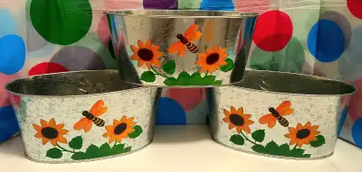 Brighten up your space with these adorable, metal flower planters featuring hand-painted sunflowers...