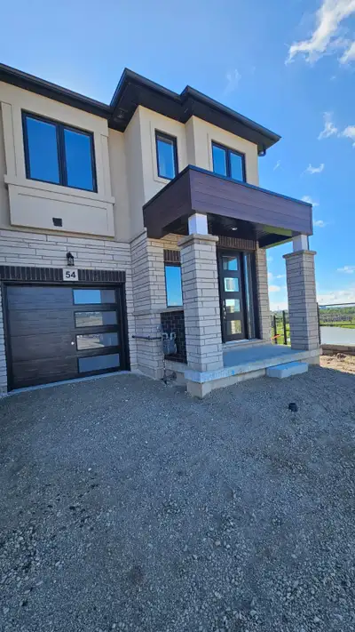 Modern End Unit Townhouse backing on to Pond offering beautiful views 3 Bedrooms + Loft 2.5 Bathroom...