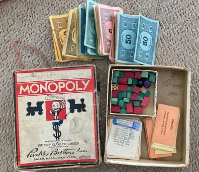 Quantity of Monopoly money wooden houses and hotels some (not all) - property pieces, chance and com...