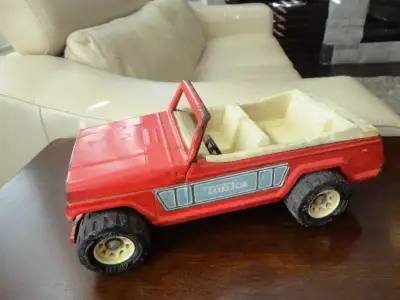I have a Red Vintage 1970's Pressed Metal Tonka Jeepster Toy Truck with XR-101 Tires. Its in decent...
