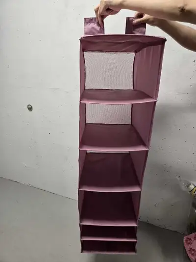 Keep your closet tidy with this hanging closet organizer, featuring six spacious shelves to store cl...