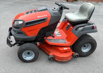 I'm selling a Husqvarna 48" yard tractor, equipped with a robust 24 HP Kawasaki engine and showing 3...