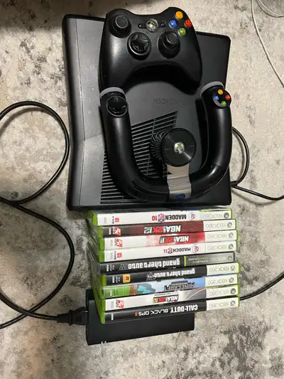 Xbox 360 S, with controller, speed wheel and 9 games. $75