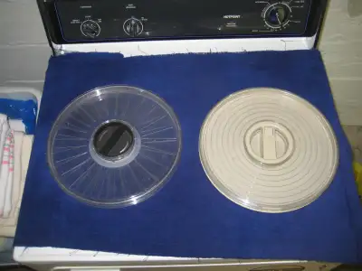A pair of 12 inch diameter plastic cases for computer tape reel storage. The case on the right is IB...