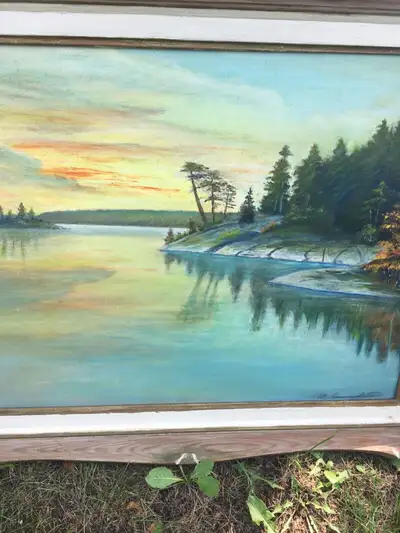 Interesting coloured oil painting of waterfront property at sunset .nice wooden frame adorns this tr...