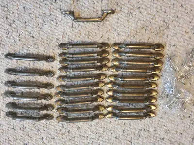 27 kitchen cabinet handles with screws in good condition, $15 for the lot