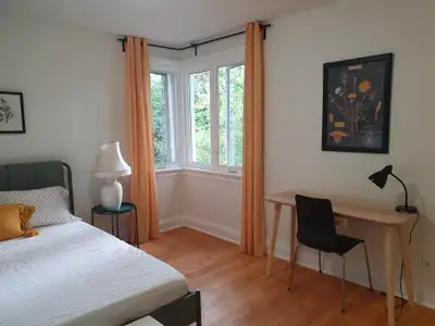 A cozy furnished master bedroom is available in a welcoming detached home shared with a friendly sem...