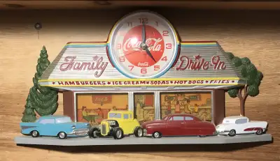 Add a touch of nostalgia to your space with this vintage Coca-Cola Family Drive-In clock, showcasing...