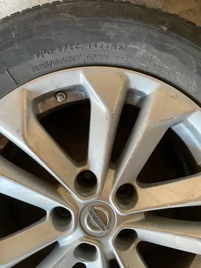 Set of 4 Bridgestone tires (225/65R17 102H M+S) mounted on original Nissan alloy rims. Tires are in...