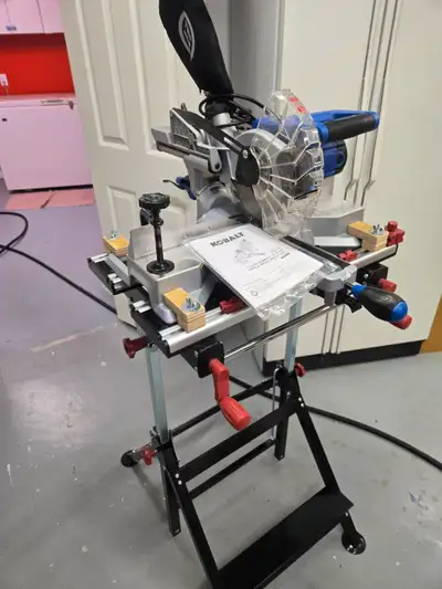 Kobalt 7 1/4" Sliding Compound Mitre Saw. Mounted on a height adjustable clamping work table. Saw an...