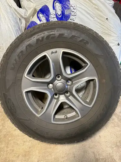 I am selling 5 pre-owned Jeep Wrangler Rims. 4 are on used all season tires 1 is alone. . Please not...