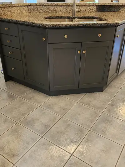 Kitchen cabinets and island with granite countertops