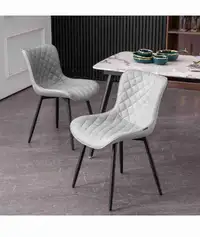 2 grey dinning chairs with black legs