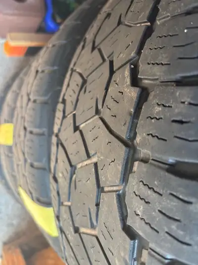 285/45R22 Open Country AT/3 tires and rim. One rim has small curb rash.
