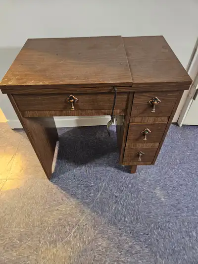 Classic vintage Coronado sewing machine built into a sturdy wooden cabinet. This is a beautiful mid-...