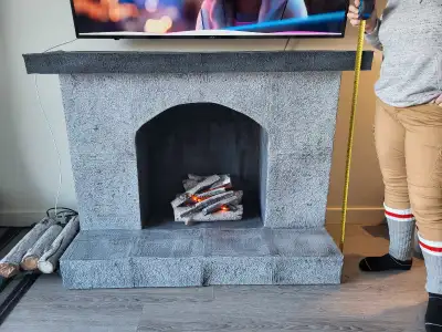 Handcrafted very unique fireplace with faux birch firelogs and lights. Measures 41"x22"x58". Decorat...