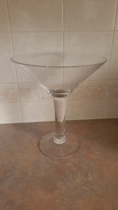 Oversize martini glass, 10" high, 9"wide, $15.00. Also an empty German liquer bottle, “Escorial Grun...
