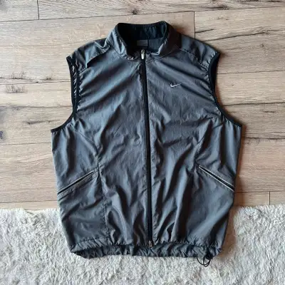 Vintage gray Nike vest jacket. Very lightweight windbreaker material, good for the summer. Has 3m re...