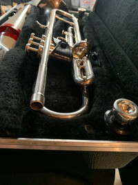 Silver trumpet with extra mutes and mouthpieces