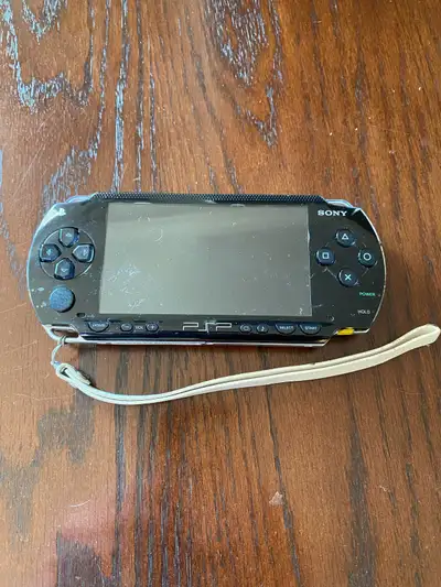 PlayStation Portable (PSP) 1001 Console. No power cord. Turns on and reads disks but turns off when...