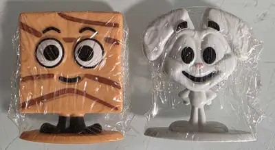 Two cereal character figurines still in their original packaging. Cinnamon Toast Crunch and Trix Rab...