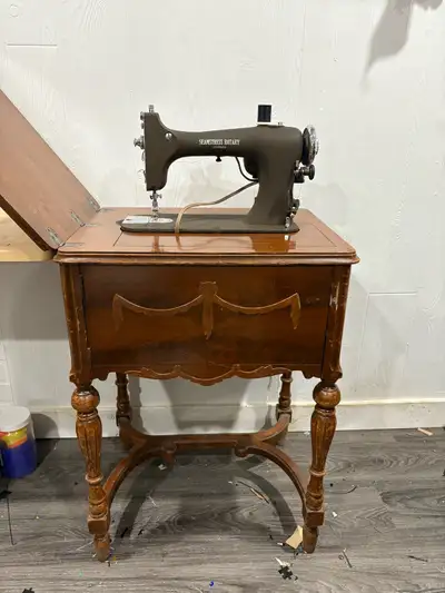 Working Antique sewing machine in a beautiful cabinet Looking to get $400 OBO