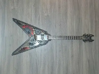 This unique metal guitar sculpture is a striking piece of art, handcrafted from repurposed chains an...