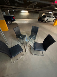 glass round dining tables w/ four chairs