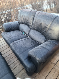 Black leather love seat and couch